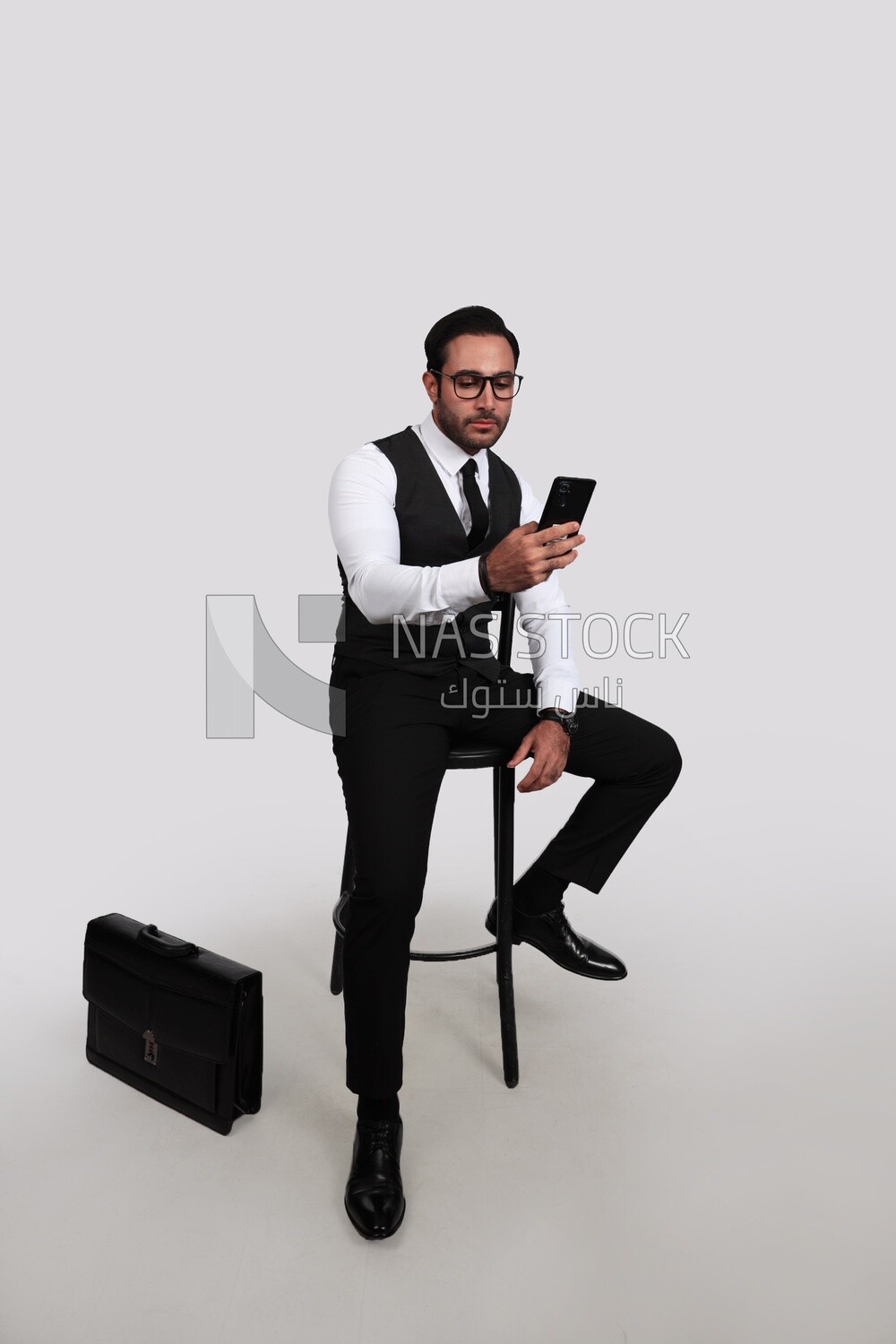 Photo of a businessman with a formal suit checking his mobile phone, business development and partnerships, business meeting, Model