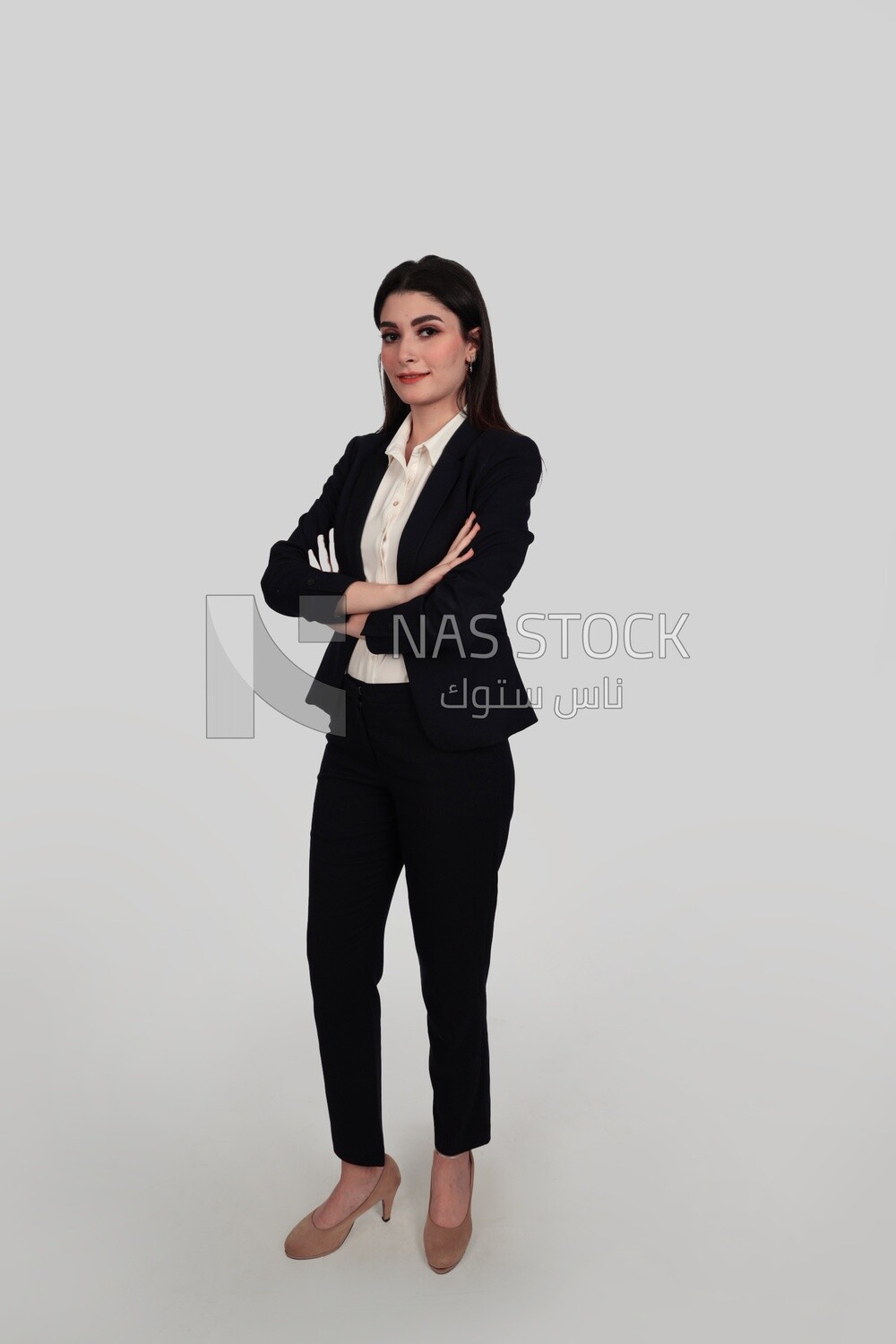 Photo of a businesswoman standing with crossed hands, meeting at the workplace, discussing work tasks, taking notes on the board