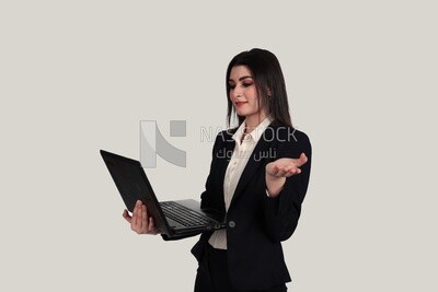 Photo of a businesswoman with a formal suit holding a laptop, business development and partnerships, business meeting, Model