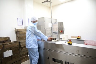 Factory worker with a machine