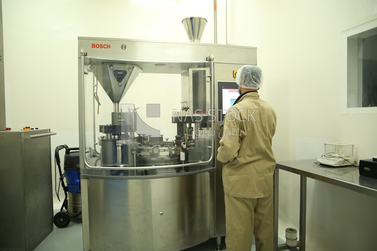 Factory worker operating a machine