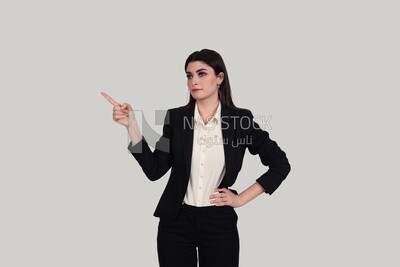 Photo of a businesswoman with formal wear standing on a white background pointing away, business development and partnerships, business meeting, Model