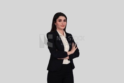 Photo of a businesswoman standing with crossed hands, meeting at the workplace, discussing work tasks, taking notes on the board