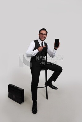 Photo of a businessman with a formal suit holding his mobile phone, business development and partnerships, business meeting, Model