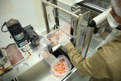 Pecialist who removes invalid Medication tablets from the manufacturing stage