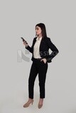 Photo of a businesswoman with formal wear holding a mobile phone, business development and partnerships, business meeting, Model