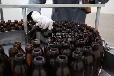 Worker sorts bottles before filling medicines into them