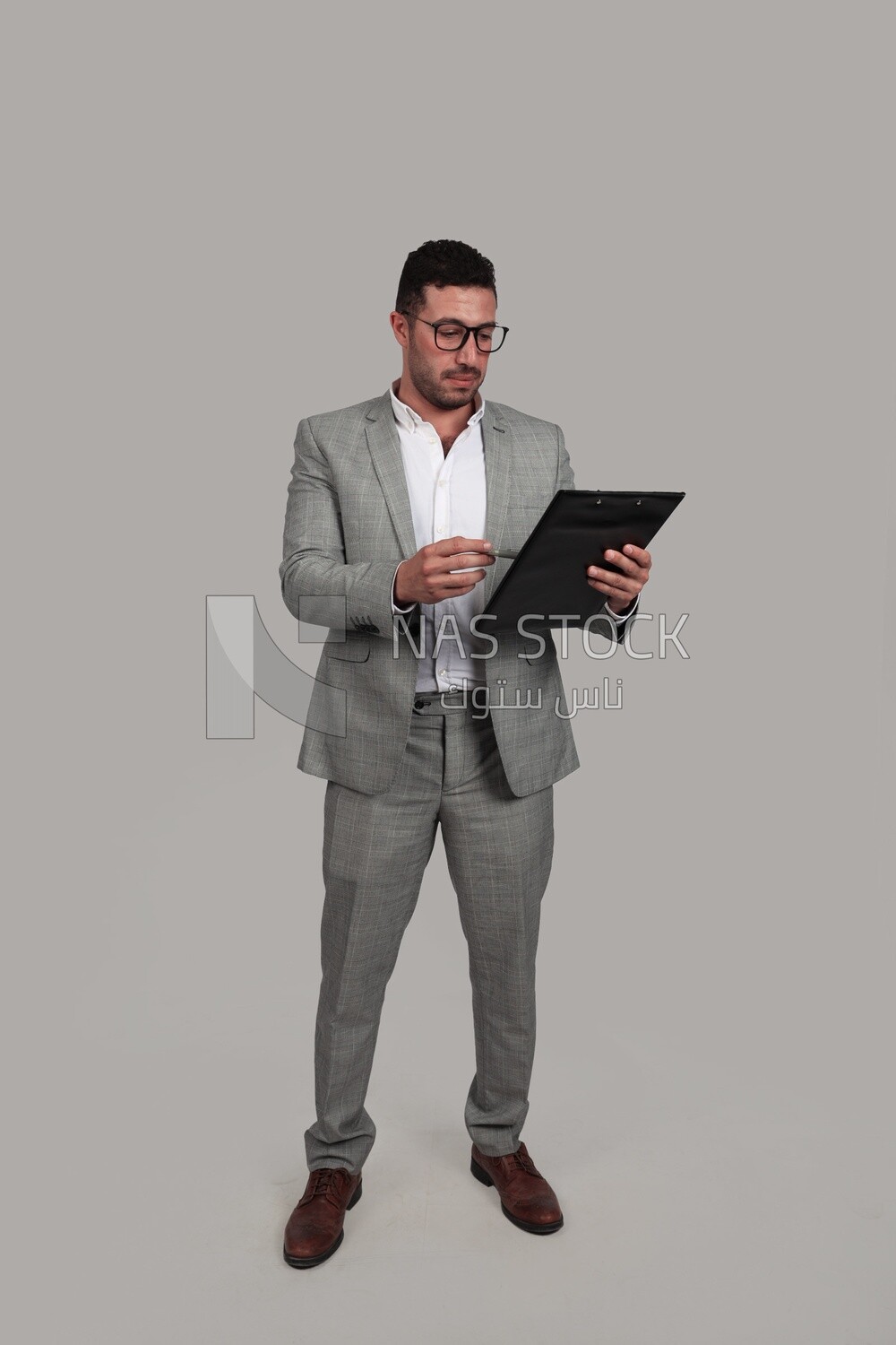Photo of a businessman in a business suit checking documents, business development and partnerships, business meetings, models