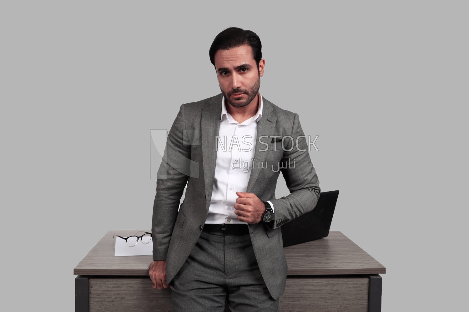 Photo of a businessman in a formal suit leaning on the office, business development and partnerships, business meeting, model