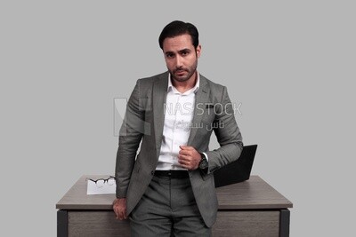 Photo of a businessman in a formal suit leaning on the office, business development and partnerships, business meeting, model