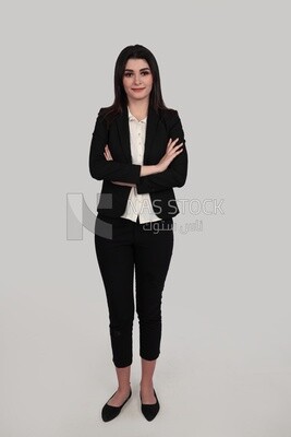 Photo of a businesswoman standing with crossed hands, meeting at the workplace, discussing work tasks