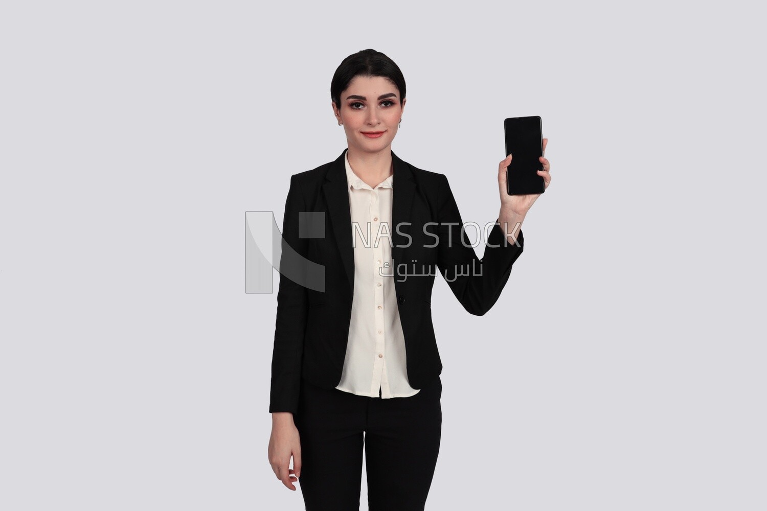 Photo of a businesswoman with a formal suit holding her mobile phone, business development and partnerships, business meeting, Model