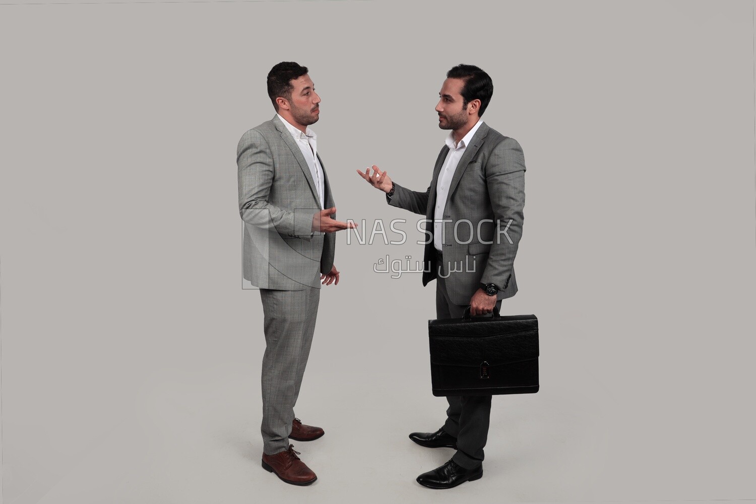 Photo of two men standing together, discussing work, business development and partnerships, business meeting, Model