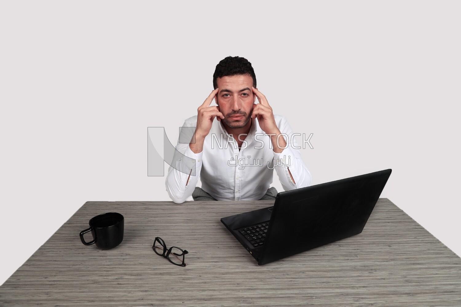 Photo of a businessman with a formal suit sitting at a desk working on a laptop thinking, business development and partnerships, business meeting, Model