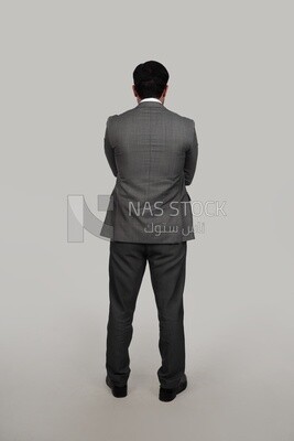 Back view of a businessman in a formal suit with crossed hands, business development and partnerships, business meeting, Model