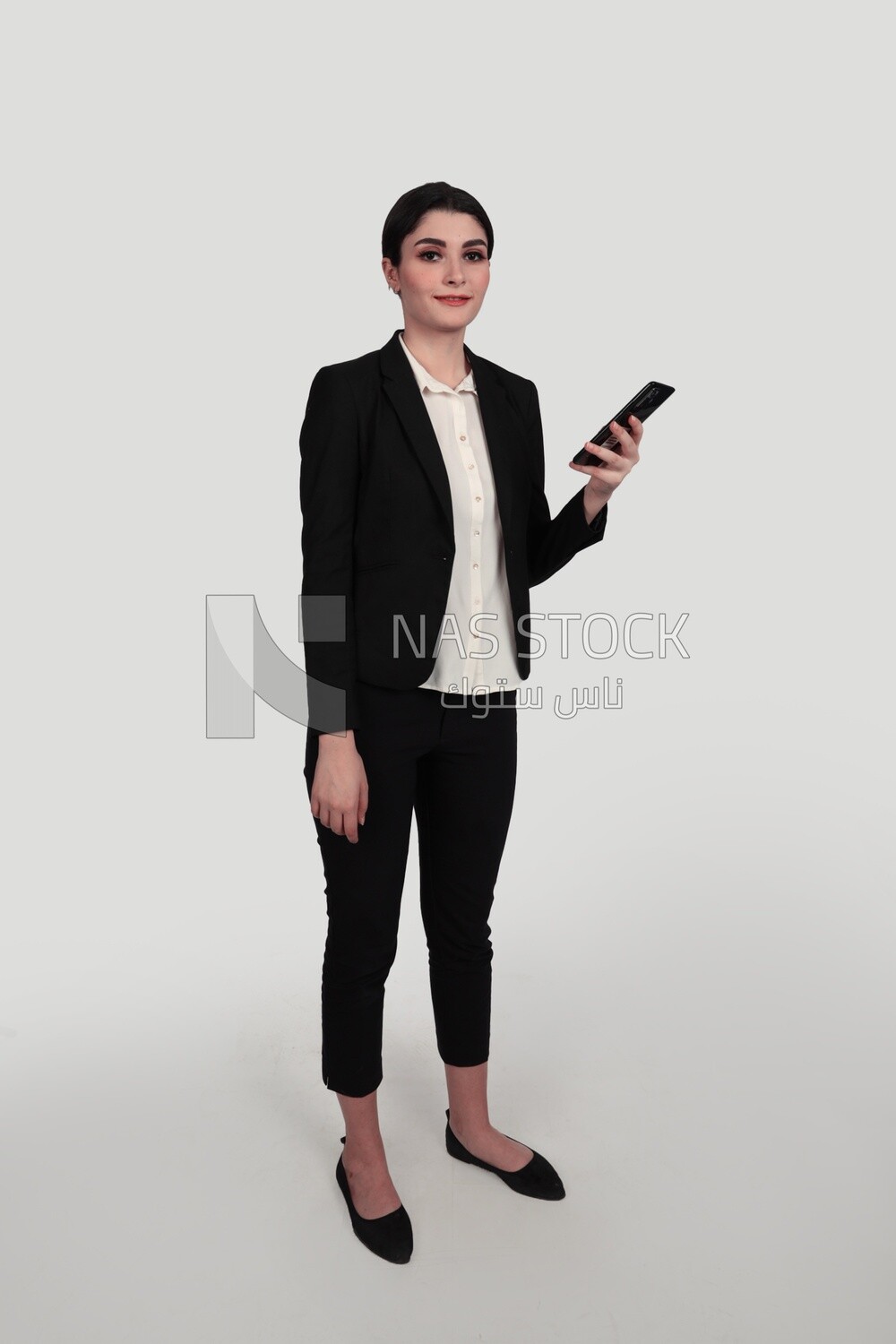 Photo of a businesswoman in formal wear standing and checking her mobile, business development and partnerships, business meeting, Model