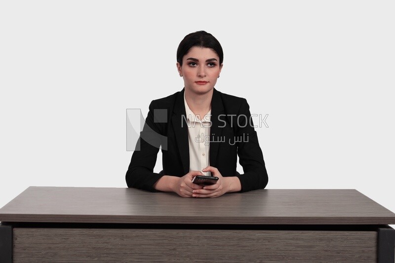 Photo of a businesswoman in formal wear sitting on the desk and checking her mobile, business development and partnerships, business meeting, Model