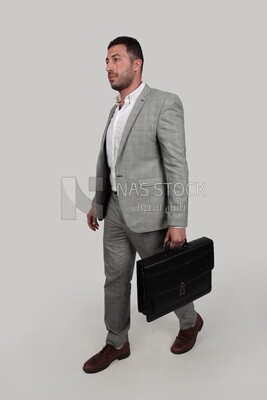 Photo of a businessman with a formal suit holding a leather bag, business development and partnerships, business meeting, Model