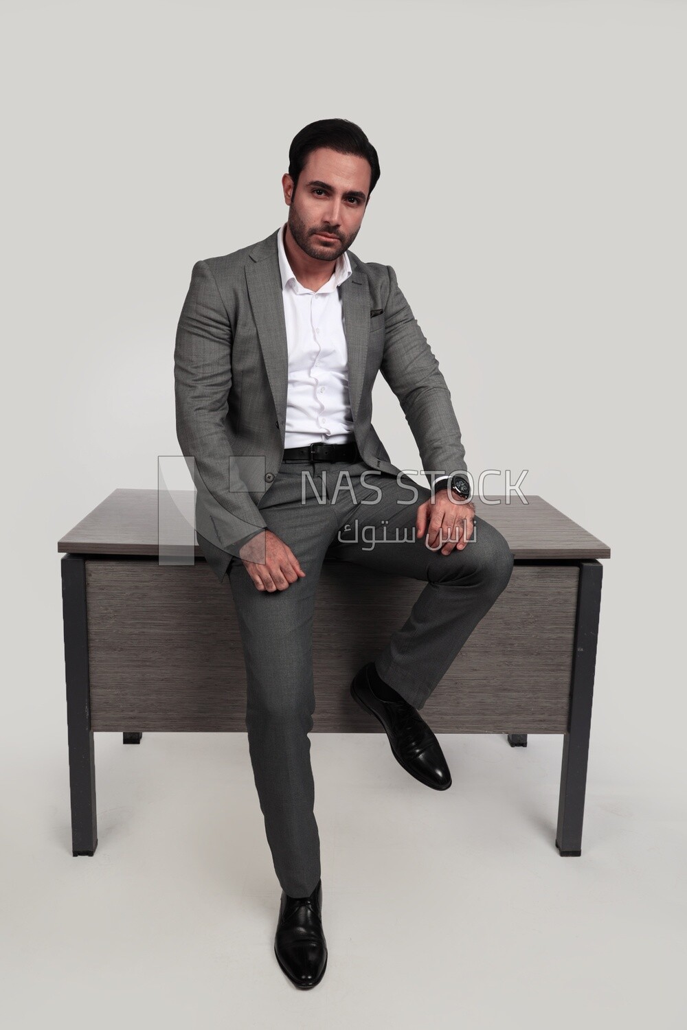 Photo of a businessman in a formal suit leaning on the office, business development and partnerships, business meeting, model