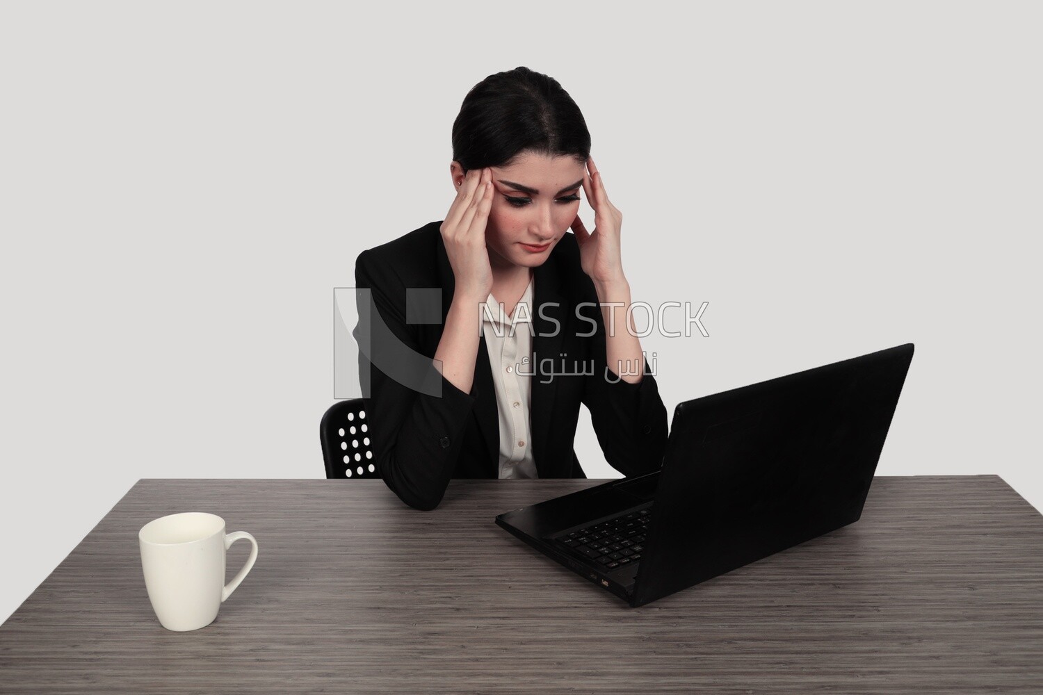 Photo of a businesswoman with a formal suit sitting at a desk working on a laptop looking tired, business development and partnerships, business meeting, Model