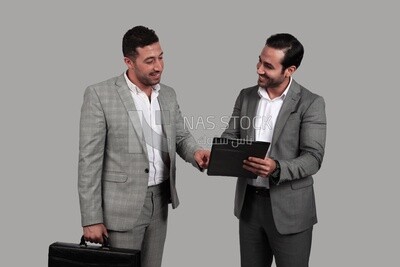 Photo of two men standing together, discussing work, business development and partnerships, business meeting, Model