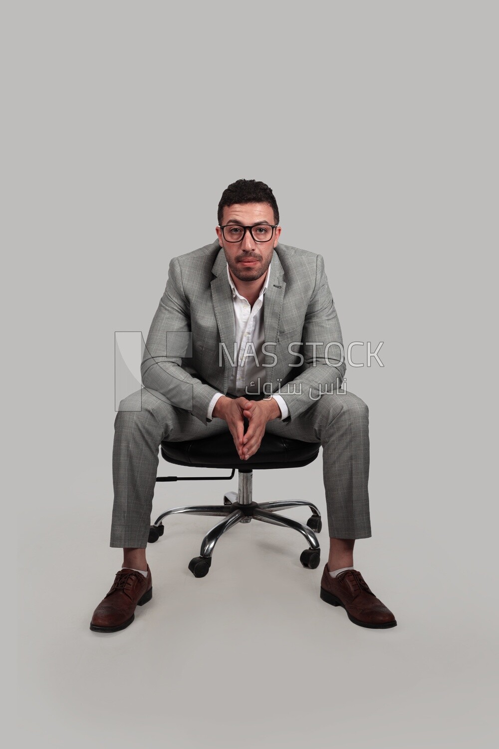 Photo of a businessman with formal wear sitting on a chair, business development and partnerships, business meeting, Model