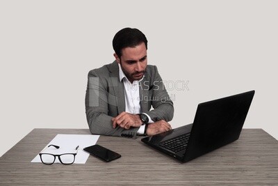 Photo of a businessman with a formal suit sitting at a desk working on a laptop, business development and partnerships, business meeting, Model