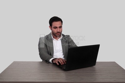 Photo of a businessman with a formal suit sitting at a desk working on a laptop, business development and partnerships, business meeting, Model