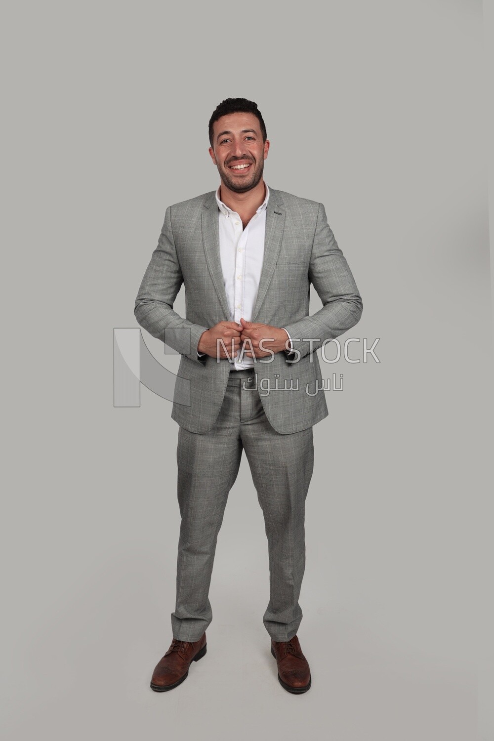 Photo of a businessman with a formal suit holding his hand on the suit button, business development and partnerships, business meeting, Model