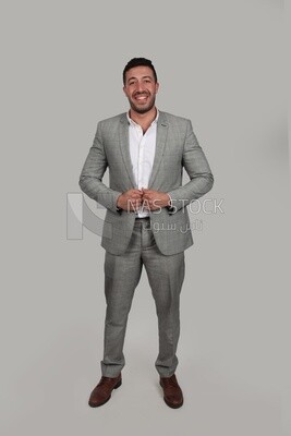 Photo of a businessman with a formal suit holding his hand on the suit button, business development and partnerships, business meeting, Model