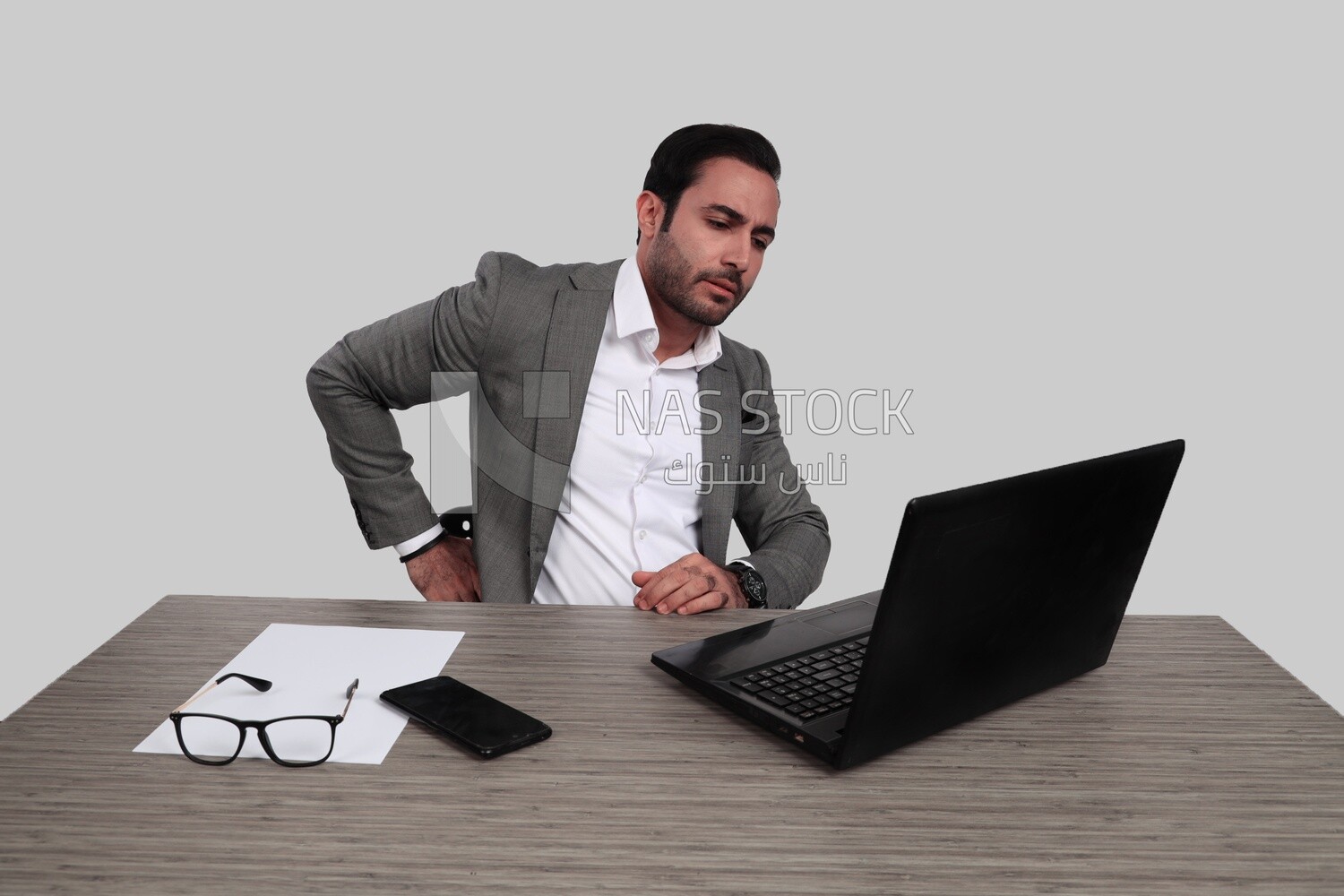 Photo of a businessman with a formal suit sitting at a desk working on a laptop, business development and partnerships, business meeting, Model