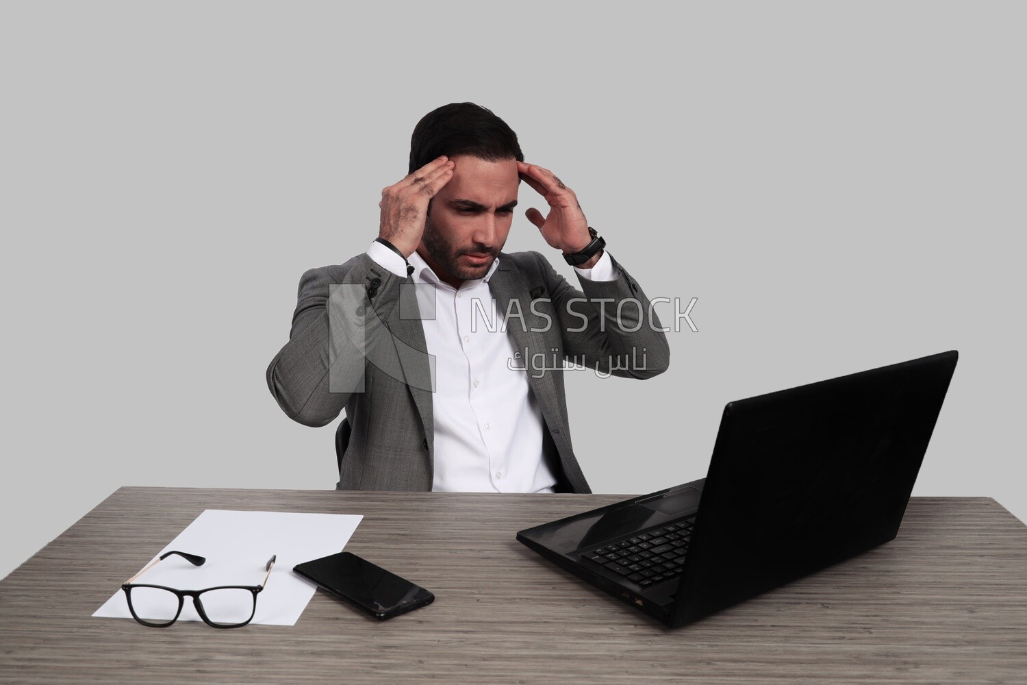 photo of a businessman with a formal suit sitting at a desk working on a laptop thinking, business development and partnerships, business meeting, Model