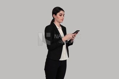 Photo of a businesswoman in formal wear standing and checking her mobile, business development and partnerships, business meeting, Model