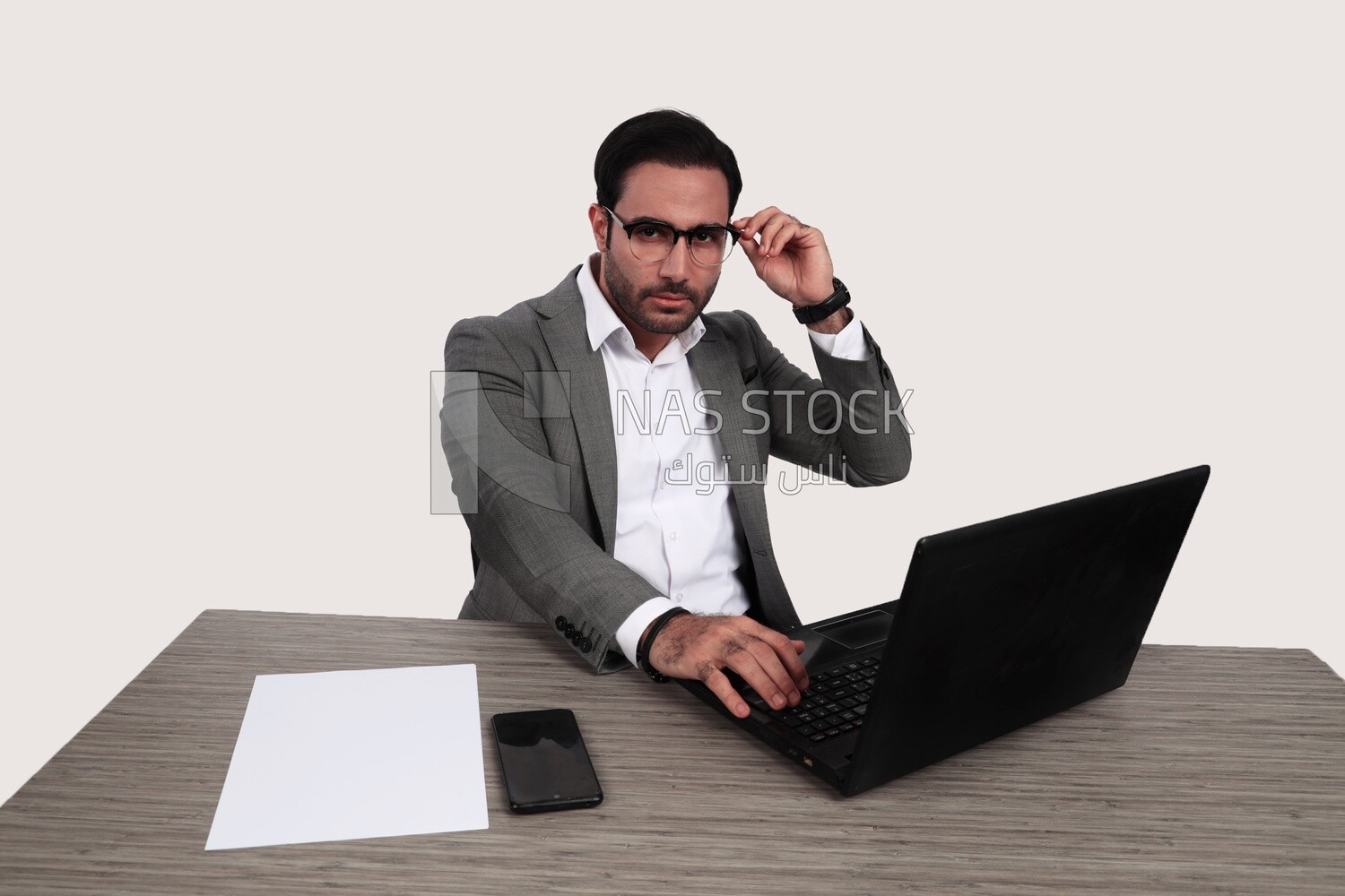 Photo of a businessman with a formal suit sitting at a desk working on a laptop, business development and partnerships, business meeting, Model