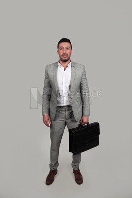 Photo of a businessman with a formal suit holding a leather bag, business development and partnerships, business meeting, Model