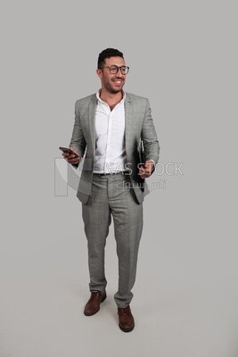 Photo of a businessman with a formal suit holding documents and checking his mobile, business development and partnerships, business meeting, Model