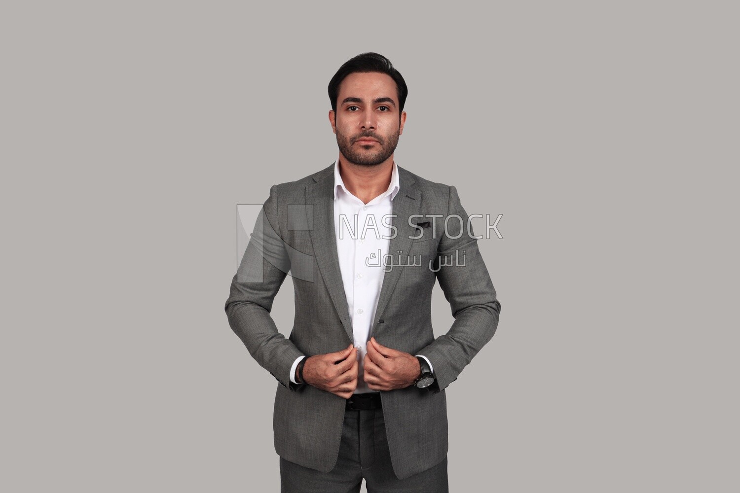 Photo of a businessman with a formal suit holding his hand on the suit button, business development and partnerships, business meeting, Model