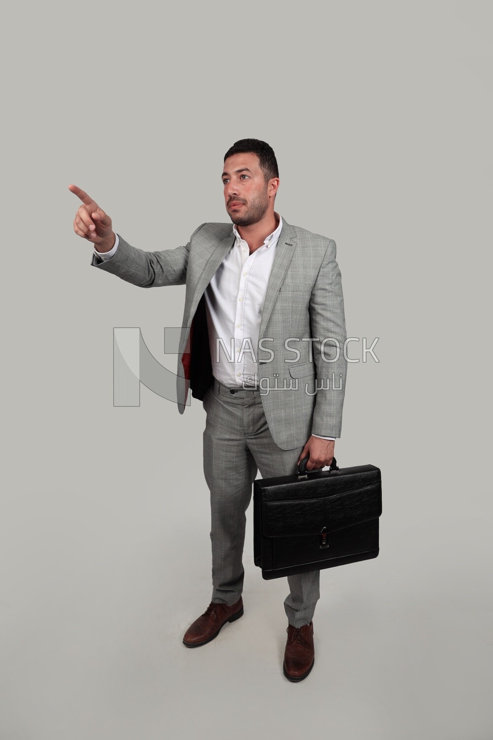 Photo of a businessman with a formal suit holding a leather bag, business development and partnerships, business meeting, Model