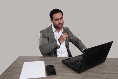 Photo of a businessman with a formal suit sitting at a desk working on a laptop, business development and partnerships, business meeting, Model