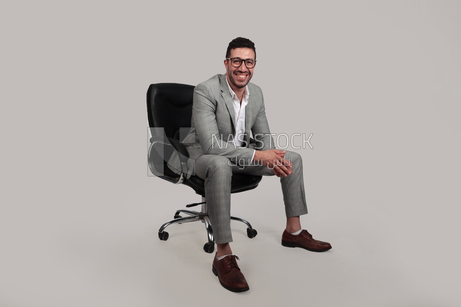 Photo of a businessman with formal wear sitting on a chair, business development and partnerships, business meeting, Model