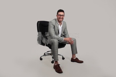 Photo of a businessman with formal wear sitting on a chair, business development and partnerships, business meeting, Model