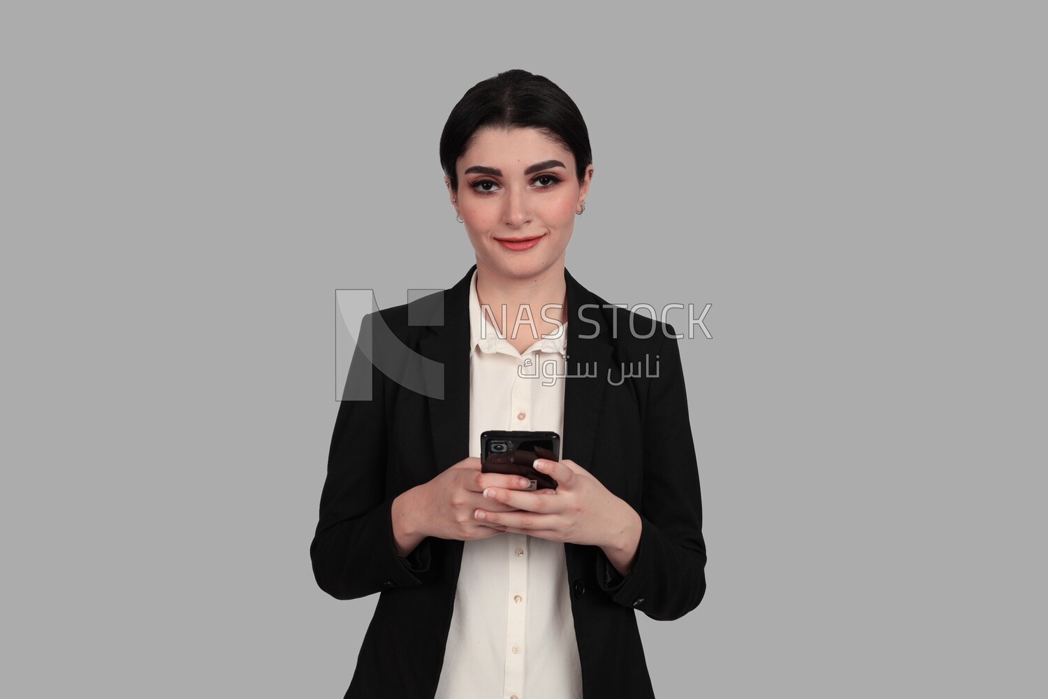 Photo of a businesswoman in formal wear standing and checking her mobile, business development and partnerships, business meeting, Model