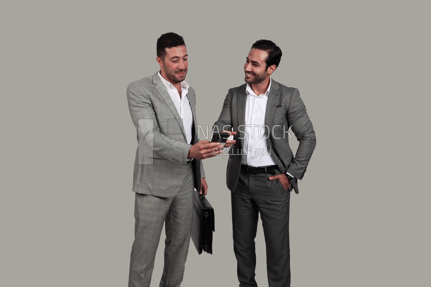 Photo of two men standing together, discussing work, business development and partnerships, business meeting, Model