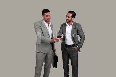 Photo of two men standing together, discussing work, business development and partnerships, business meeting, Model