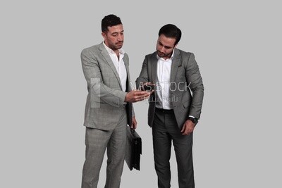 Photo of two men sitting in the office, discussing the work, business development and partnerships, business meeting, Model