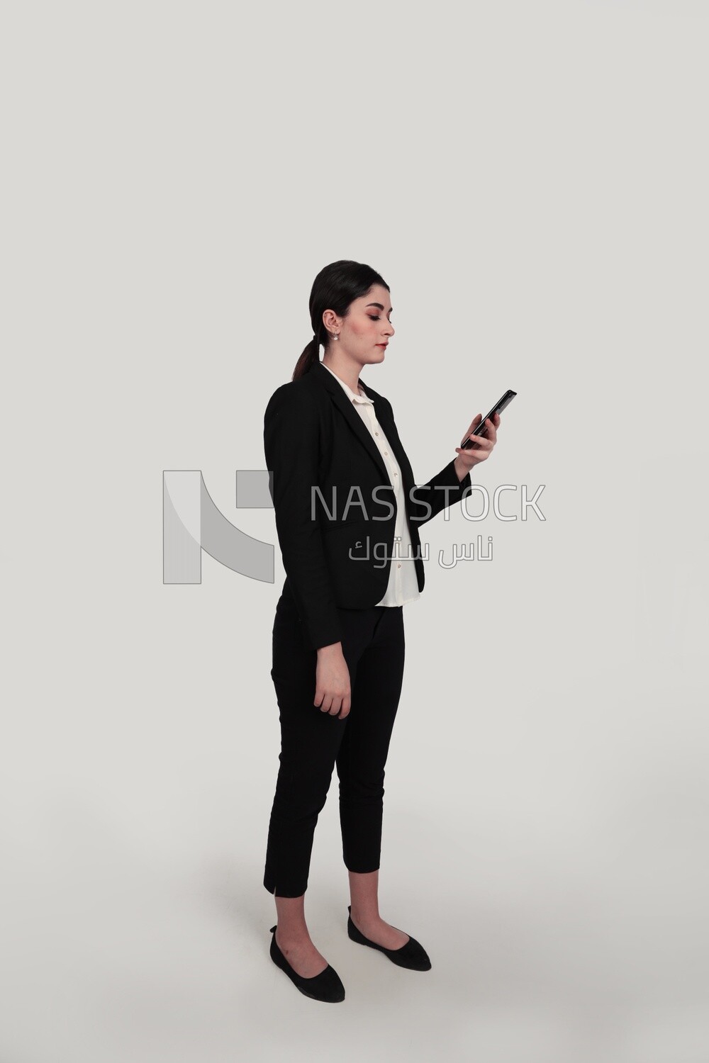 Photo of a businesswoman in formal wear standing and checking her mobile, business development and partnerships, business meeting, Model
