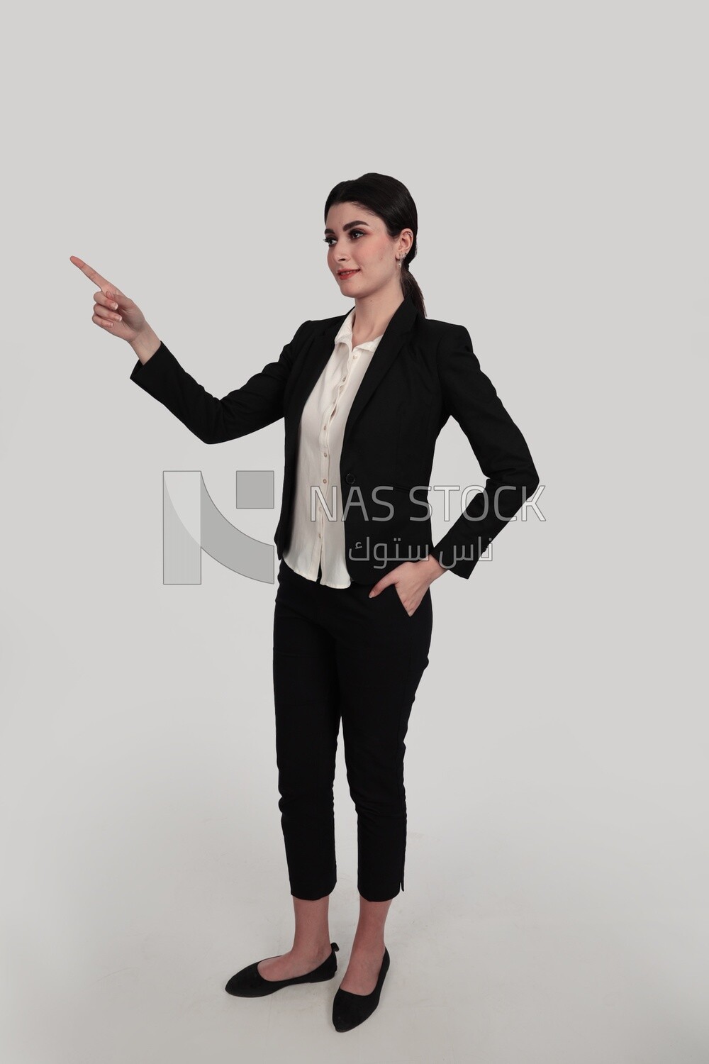Photo of a businesswoman in formal wear standing pointing away, business development and partnerships, business meeting, Model