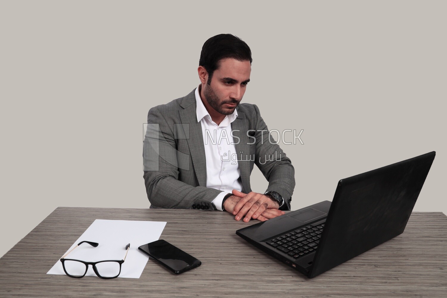 Photo of a businessman with a formal suit sitting at a desk working on a laptop, business development and partnerships, business meeting, Model