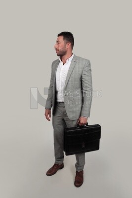 Photo of a businessman with a formal suit holding a leather bag, business development and partnerships, business meeting, Model