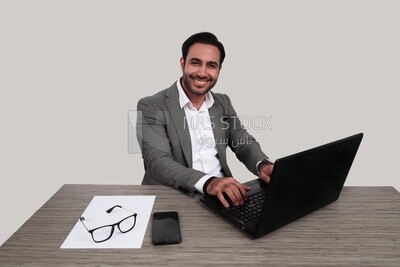 Photo of a businessman with a formal suit sitting at a desk working on a laptop, business development and partnerships, business meeting, Model